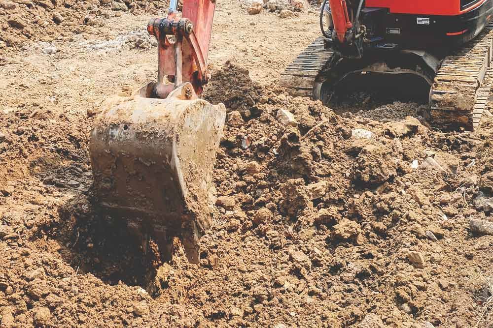 A Bulldozer Is Digging A Hole In The Dirt — Macleay Air In West Kempsey, NSW