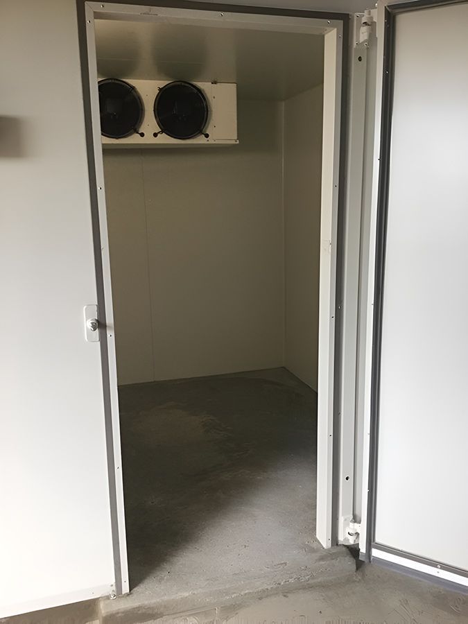 An Empty Cold Room With A Door Open And Two Fans On The Ceiling — Macleay Air In West Kempsey, NSW