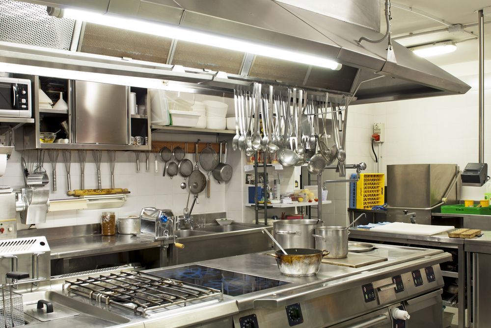 A Kitchen With A Lot Of Stainless Steel Appliances And Pots And Pans — Macleay Air In West Kempsey, NSW