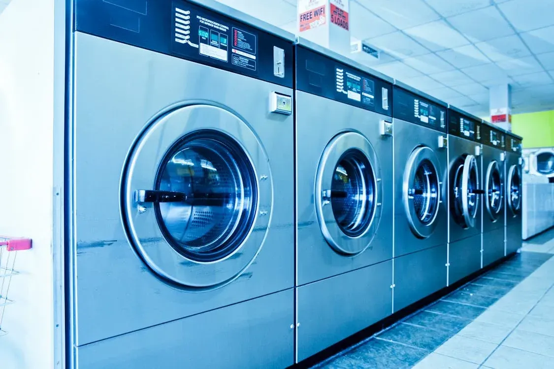 A row of washing machines in a laundromat.