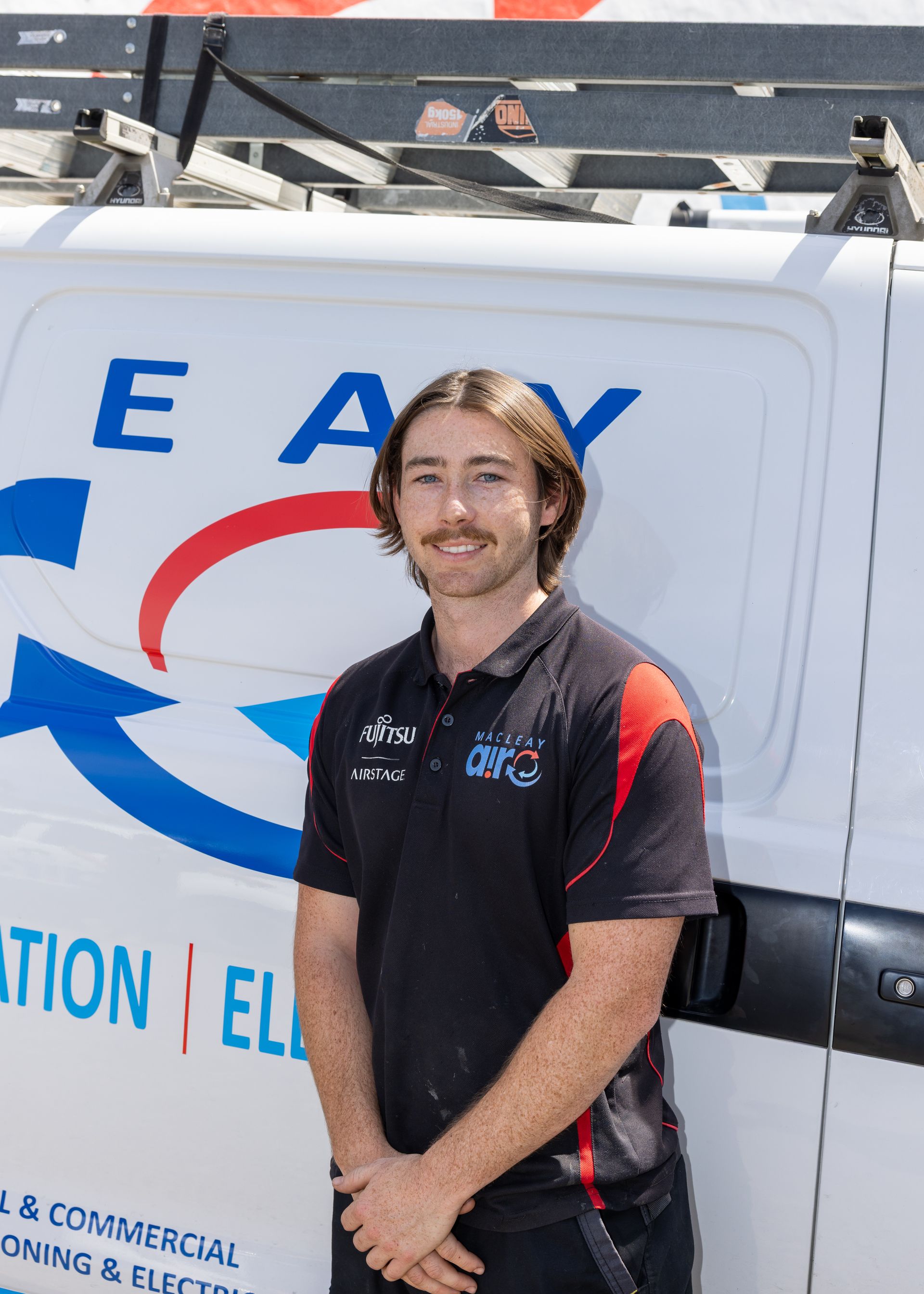 A Man Is Working On A Copper Pipe With A Wrench — Macleay Air In West Kempsey, NSW