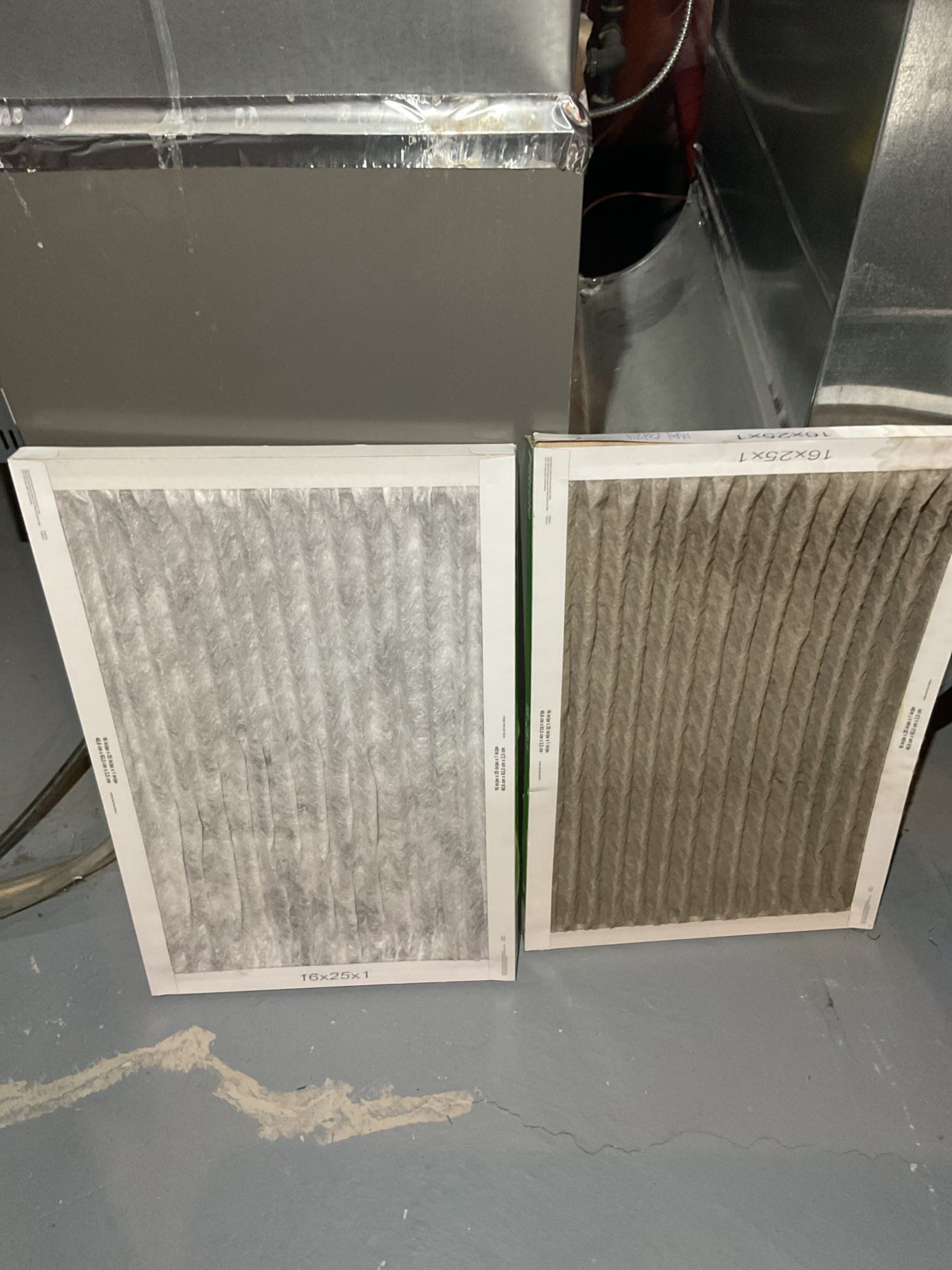 Side-by-side comparison of a clean white furnace filter and a clogged grey filter that needs replacement