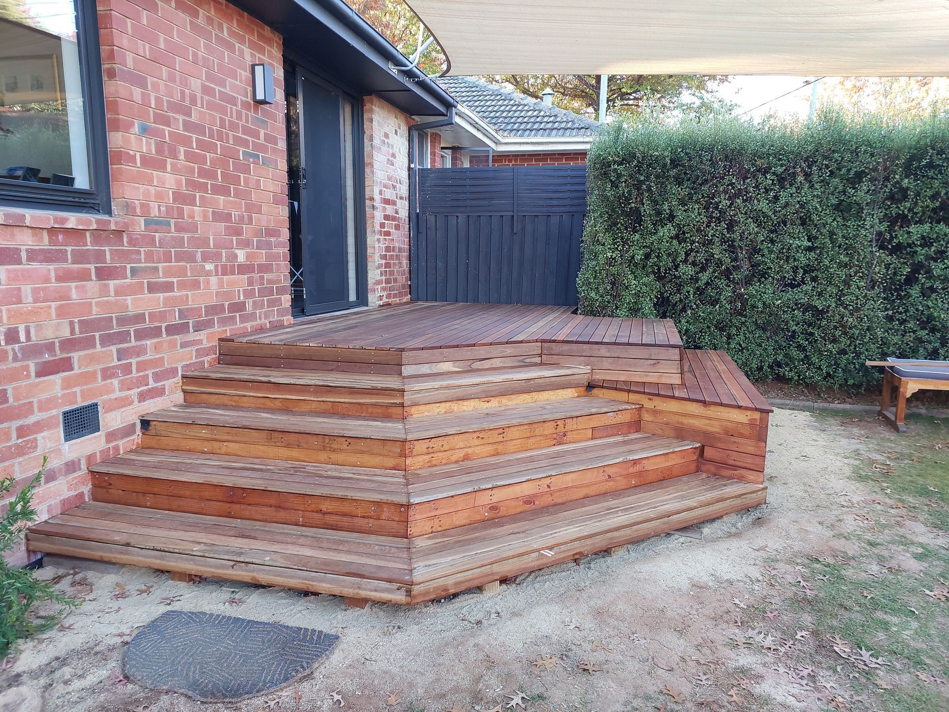Wooden Deck and Steps Next to a Brick House and a Green Hedge — Elimar Construction in Goulburn, NSW