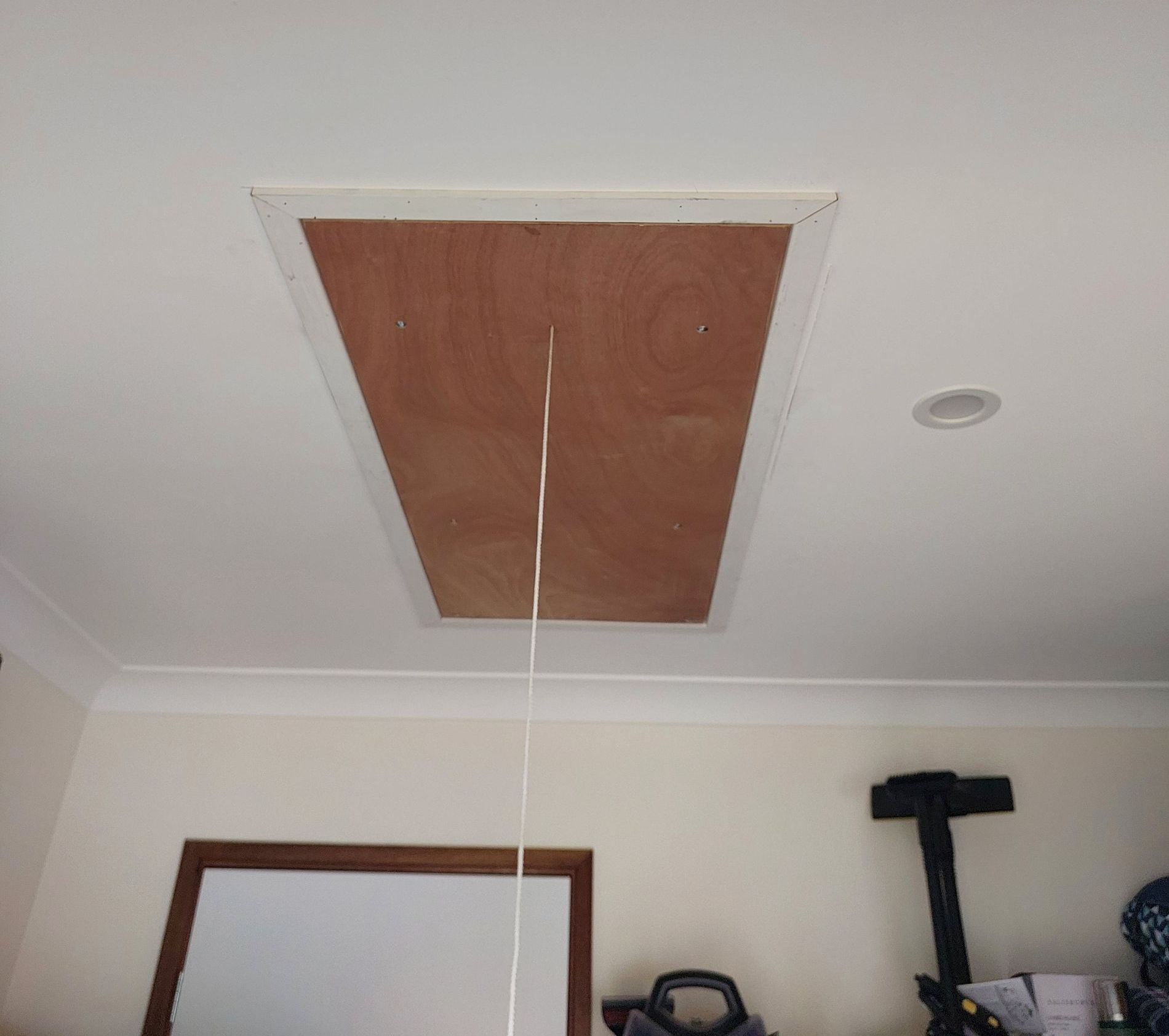 Ceiling Access Panel With Pull-down Cord. Rectangular Wooden Door in White Ceiling — Elimar Construction in Goulburn, NSW