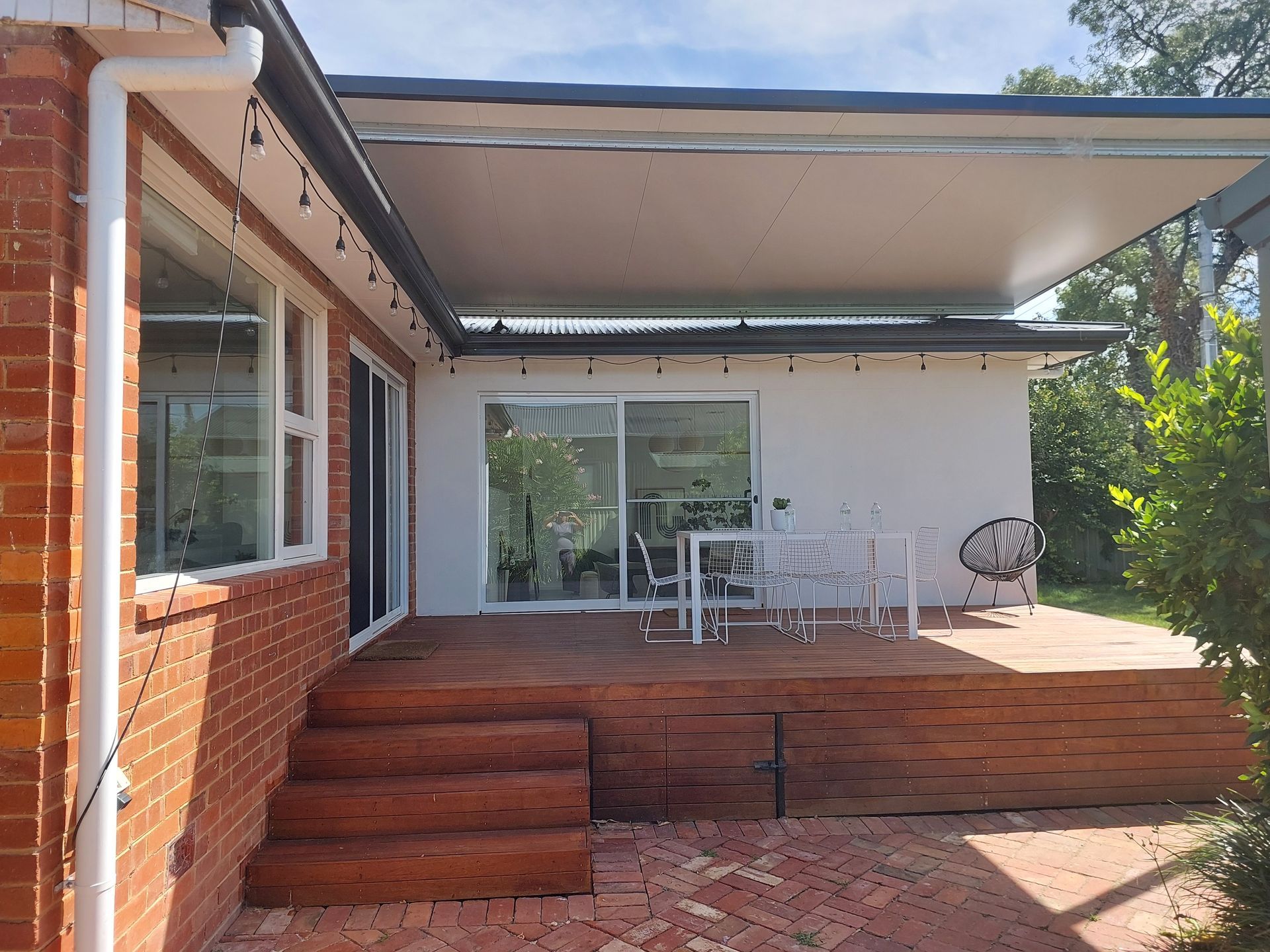 Wooden Deck and Patio With Awning Attached to a White Building With Brick exterior, Overlooking a Garden — Elimar Construction in Goulburn, NSW