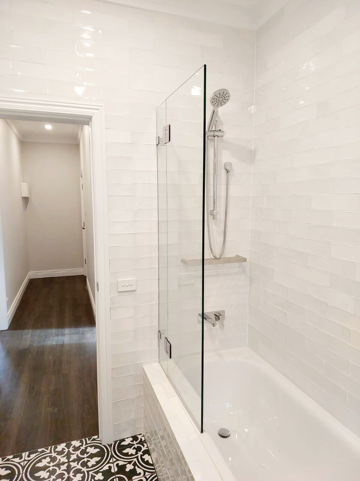 White Bathroom With Glass Shower Screen, Shower Head, and Bathtub — Elimar Construction in Goulburn, NSW