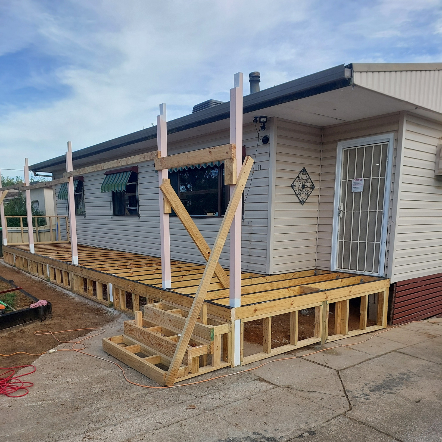 A House With a Wooden Deck Under Construction — Elimar Construction in Goulburn, NSW