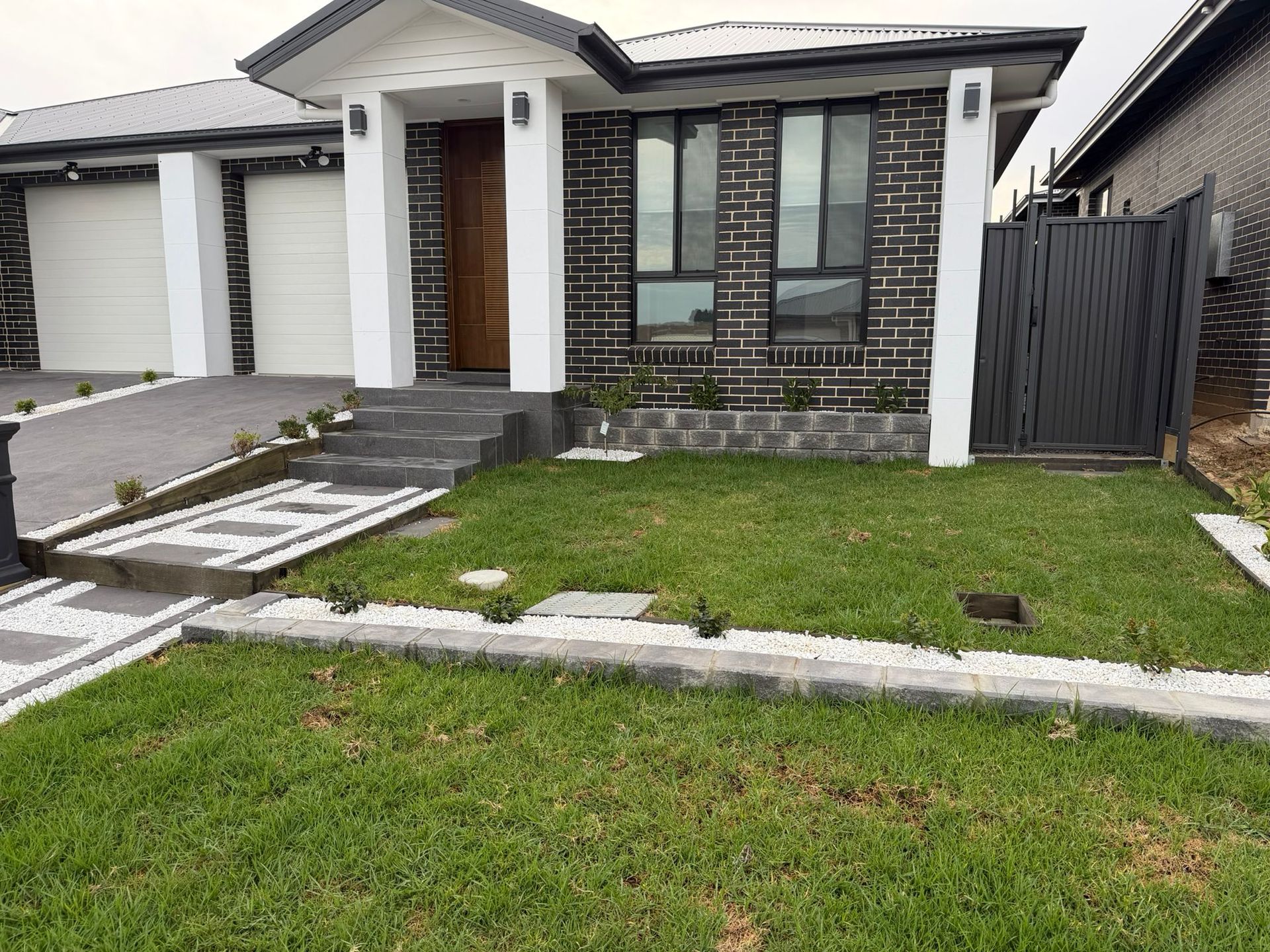 Modern single-story house with gray brick facade, white trim, driveway, and — Elimar Construction in Goulburn, NSW