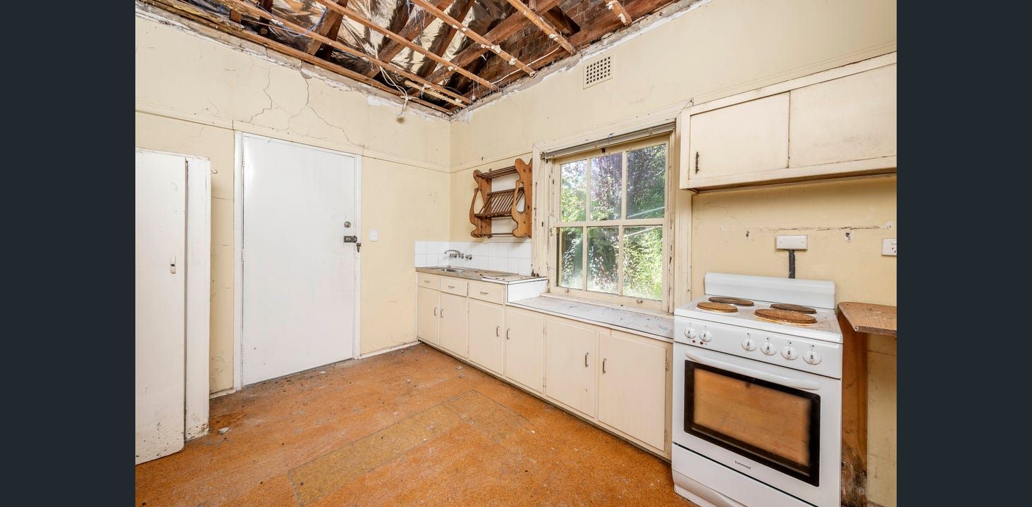 Kitchen With Damaged Ceiling, Cabinets, and Appliances — Elimar Construction in Goulburn, NSW
