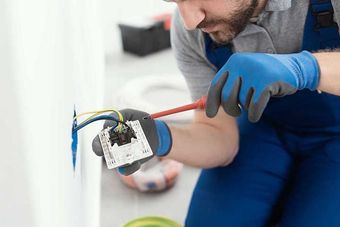 Professional electrician installing a wall socket