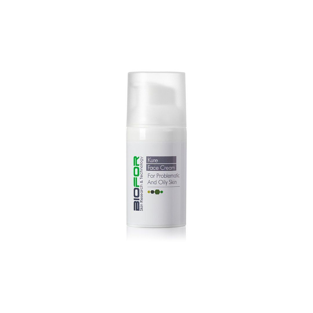 A white bottle with a green logo on it is sitting on a white surface.