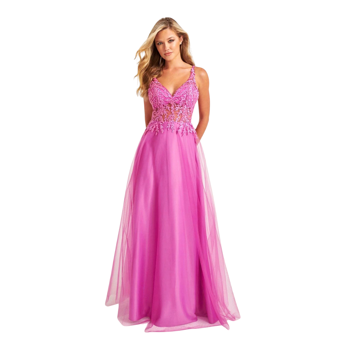 Woman in a bright pink embellished floor-length gown on a white background
