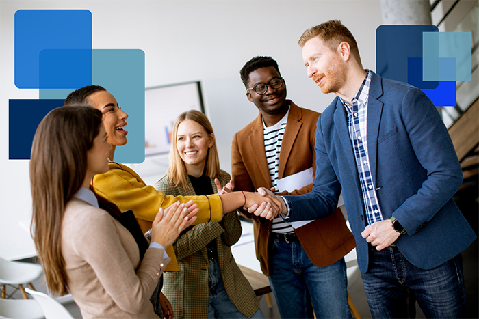 business team shaking hands and smiling