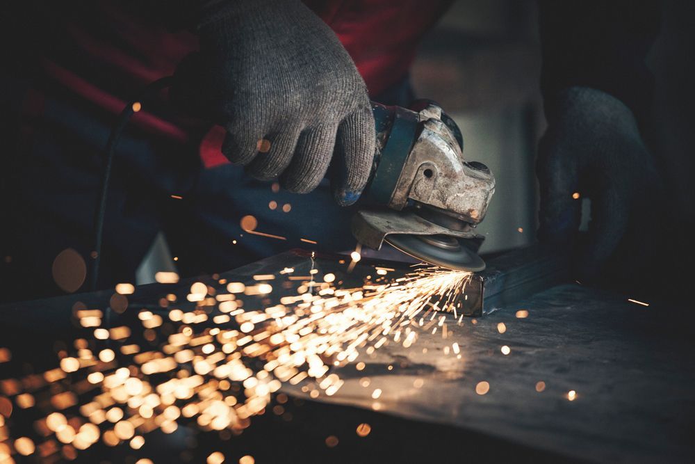 Worker Grinding A Metal — Wisconsin Rapids, WI — BDT INC Worker Grinding A Metal — Wisconsin Rapids, WI — BDT INC