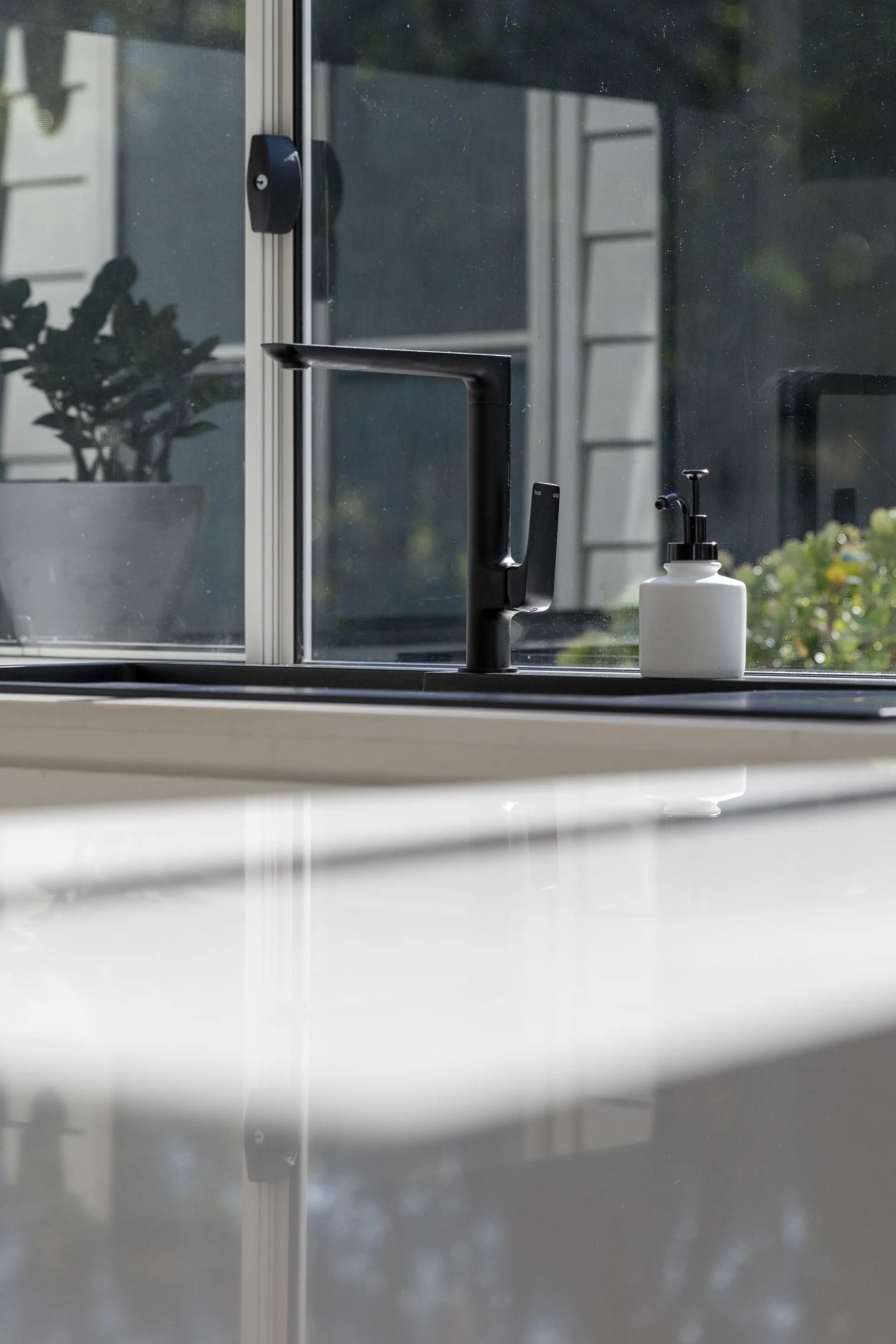 Black Kitchen Faucet and Soap Dispenser — Platinum Kitchens & Bathrooms in Grafton, NSW