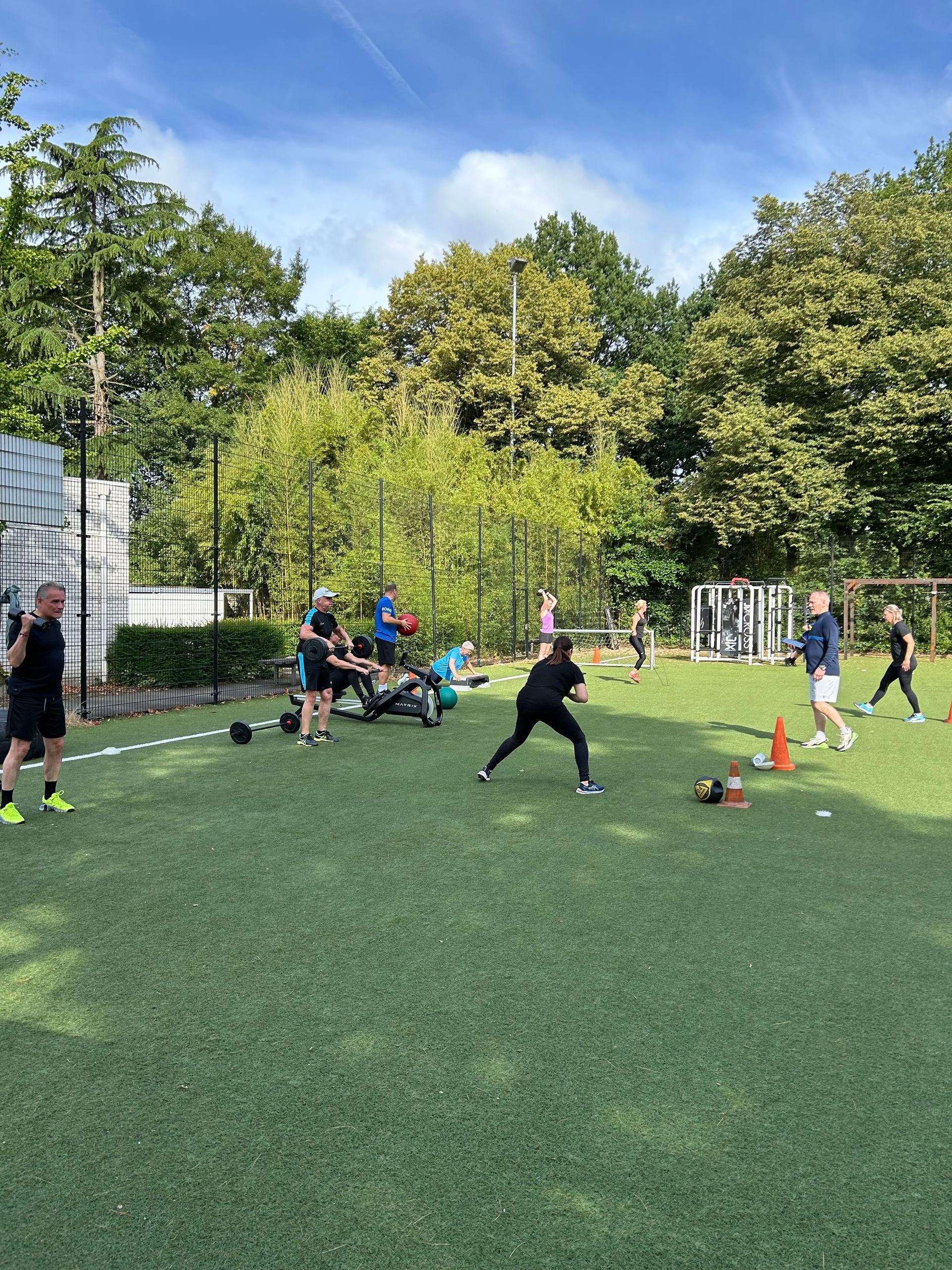 Drie vrouwen doen oefeningen voor een machine waarop cybex staat