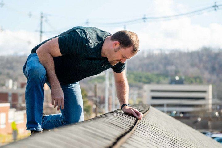 Man On The Roof House Inspecting