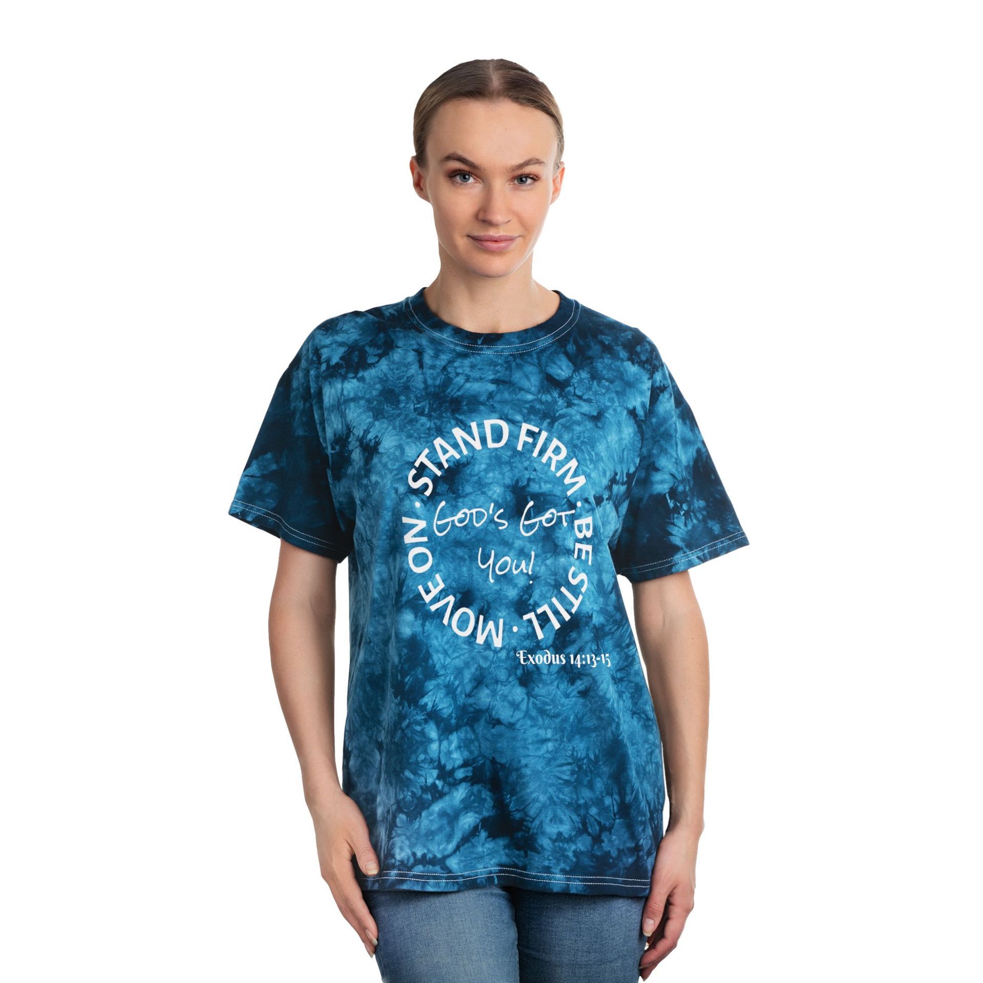 Woman wearing a blue tie-dye t-shirt with white text that says, "Stand firm, let's go, You move on, still."