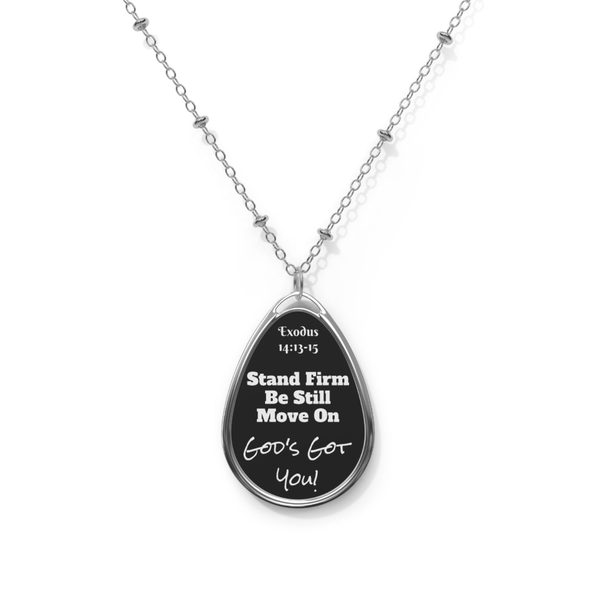 Silver pendant necklace with a black oval pendant. The pendant has the text 