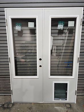 Double white doors with glass panels and a dog door against a gray background.