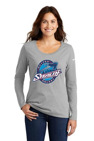 A smiling person wears a grey long-sleeved Nike shirt with a blue, white, and red Dayton Stealth hockey team logo.