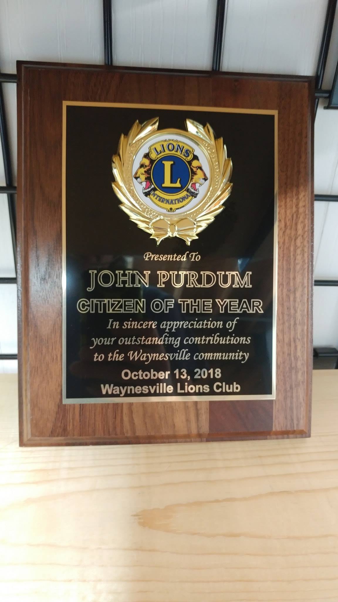 A wood-framed award plaque from the Waynesville Lions Club honoring John Purdum as Citizen of the Year, October 13, 2018.
