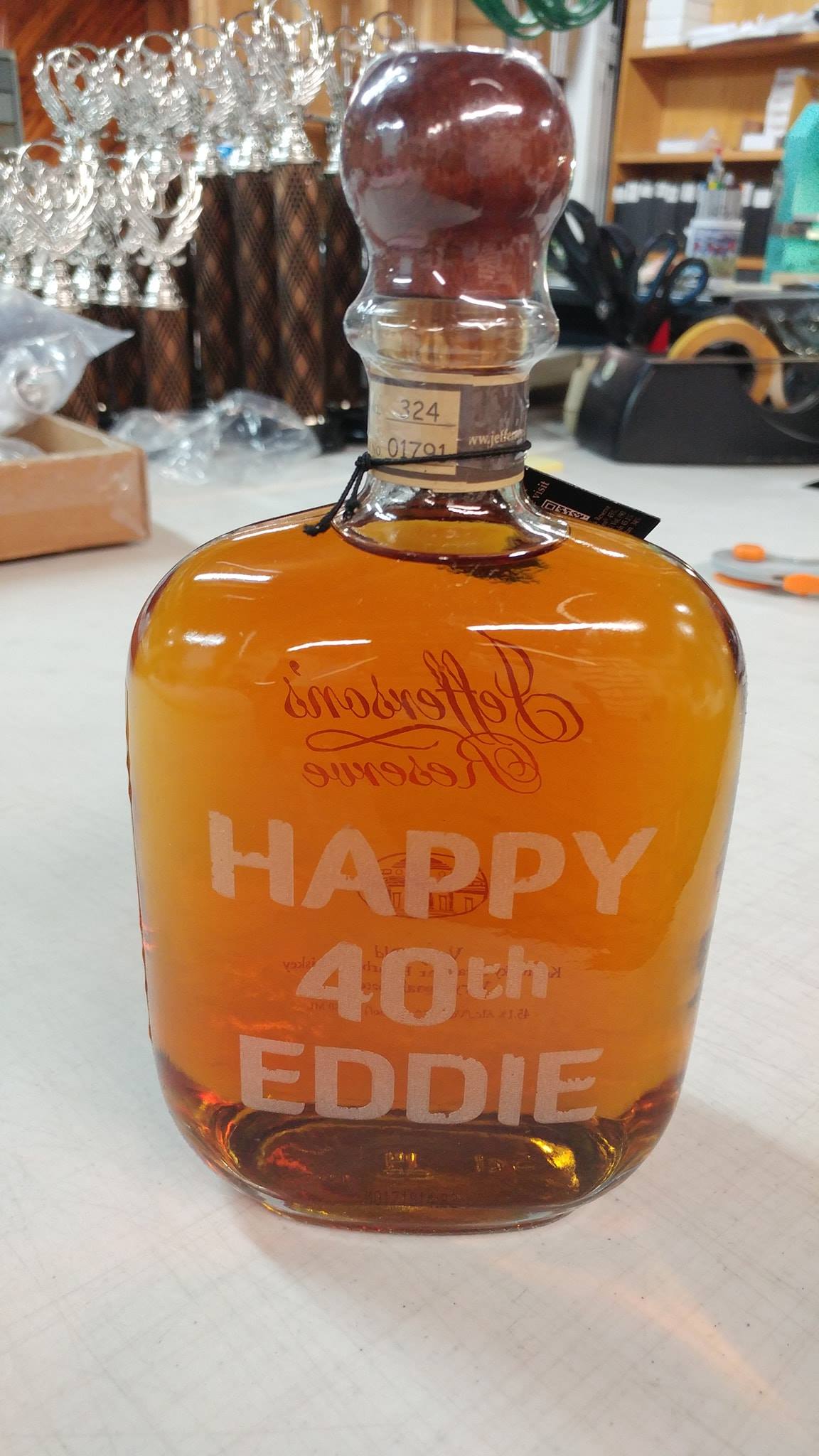 An amber-colored glass bottle engraved with