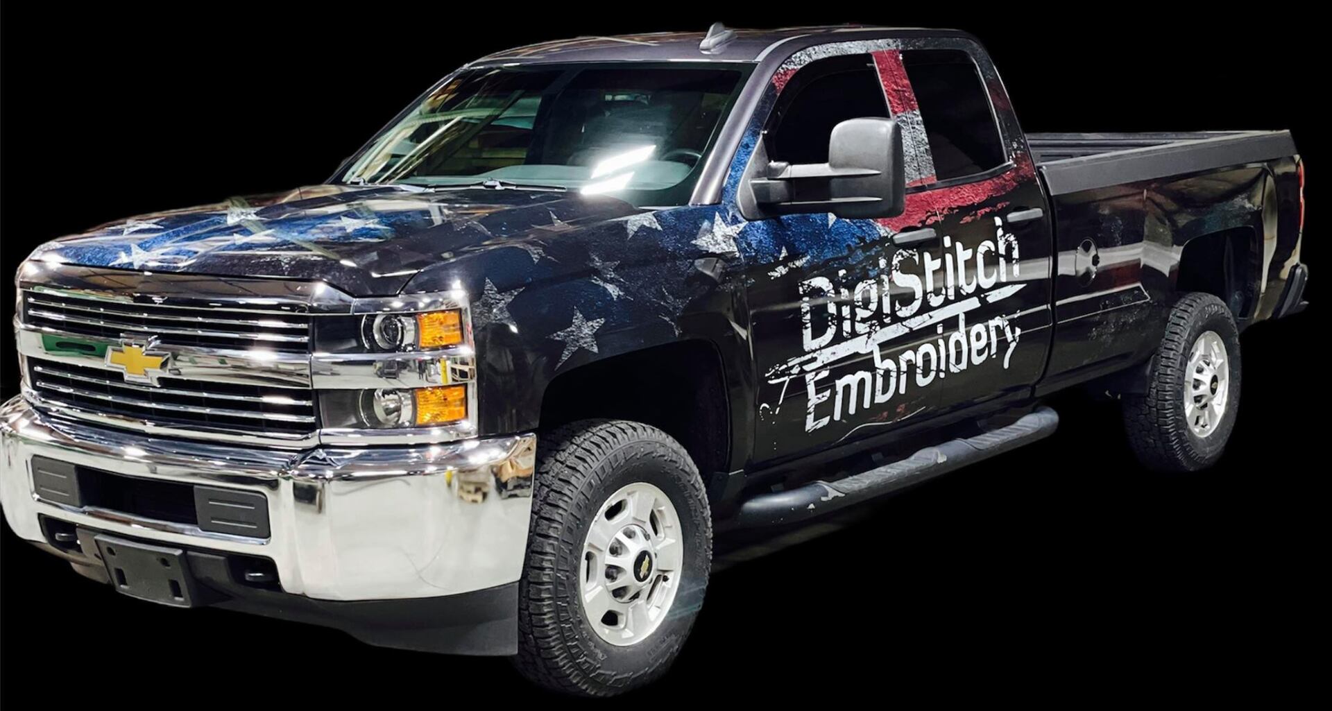 A Chevrolet pickup truck wrapped in a blue and white star pattern, branded with 