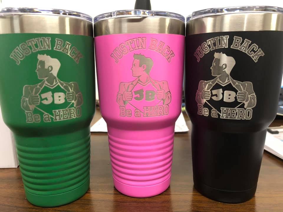 Three insulated tumblers in green, pink, and black, each engraved with a