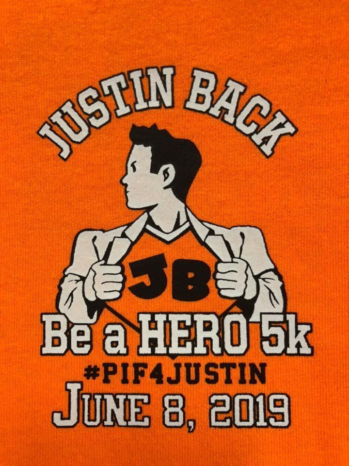 Orange t-shirt graphic showing a silhouette revealing a superhero-style
