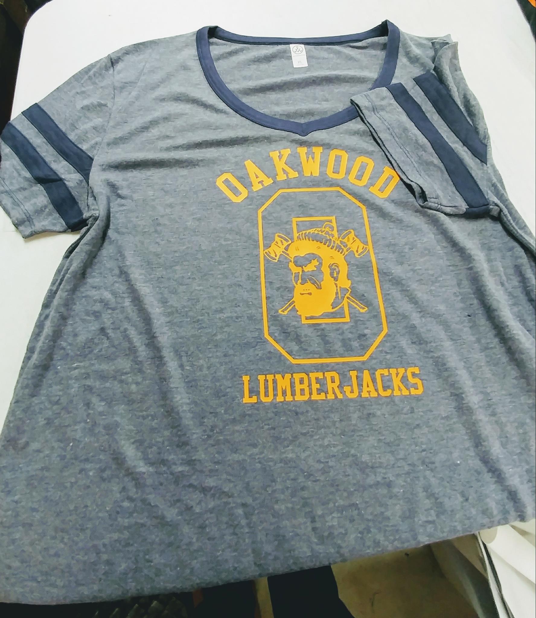 A grey v-neck t-shirt with navy blue trim, featuring