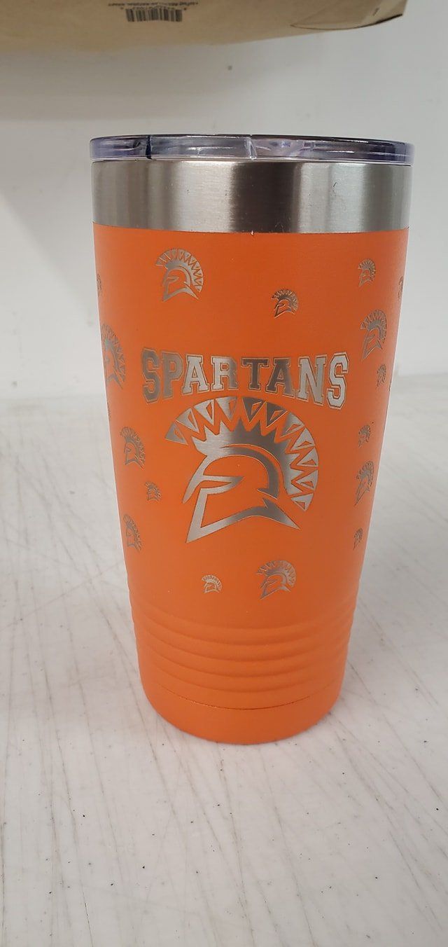 An orange insulated tumbler featuring a silver Spartan helmet logo and the word