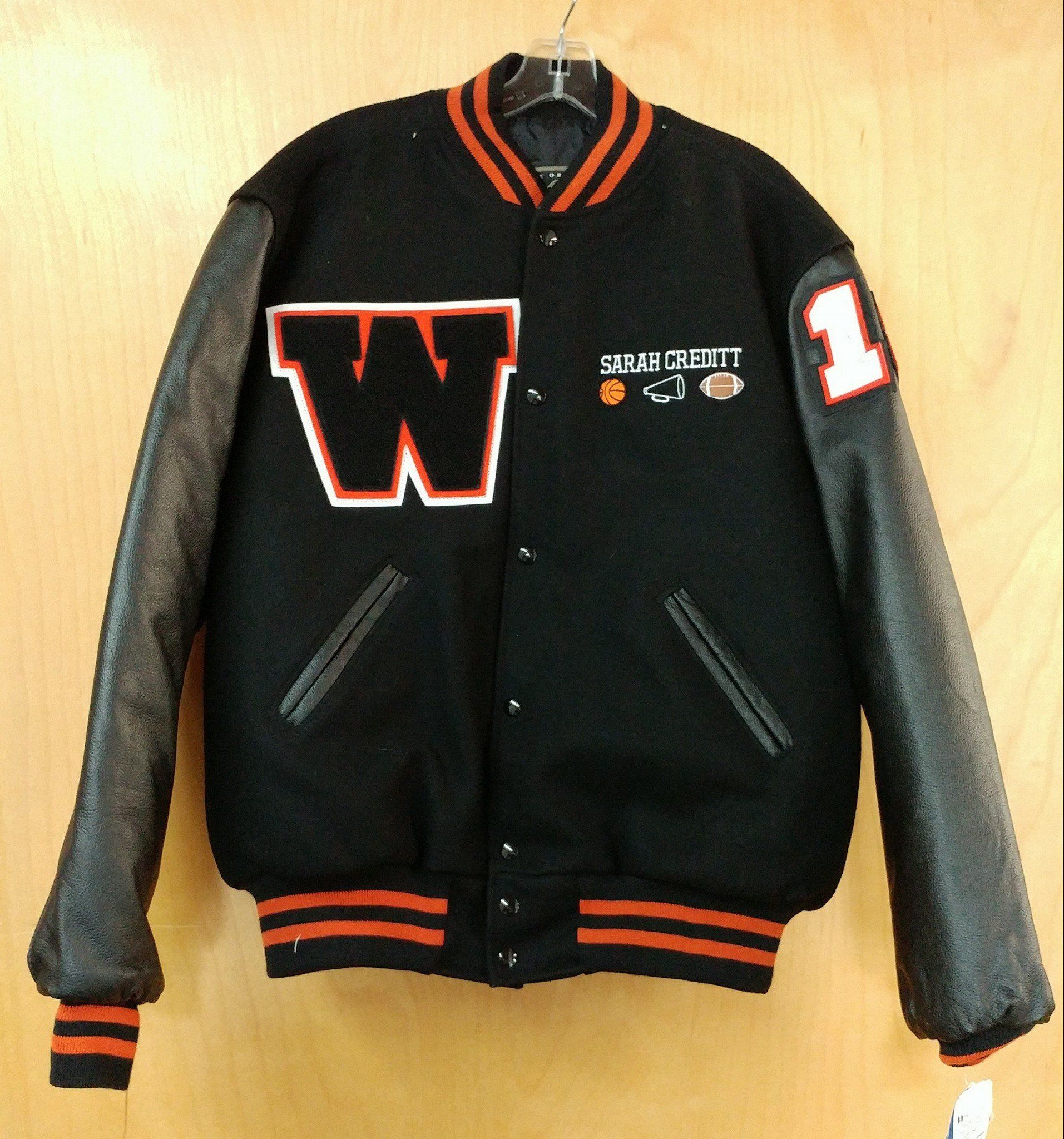 Black and orange varsity jacket with a large 