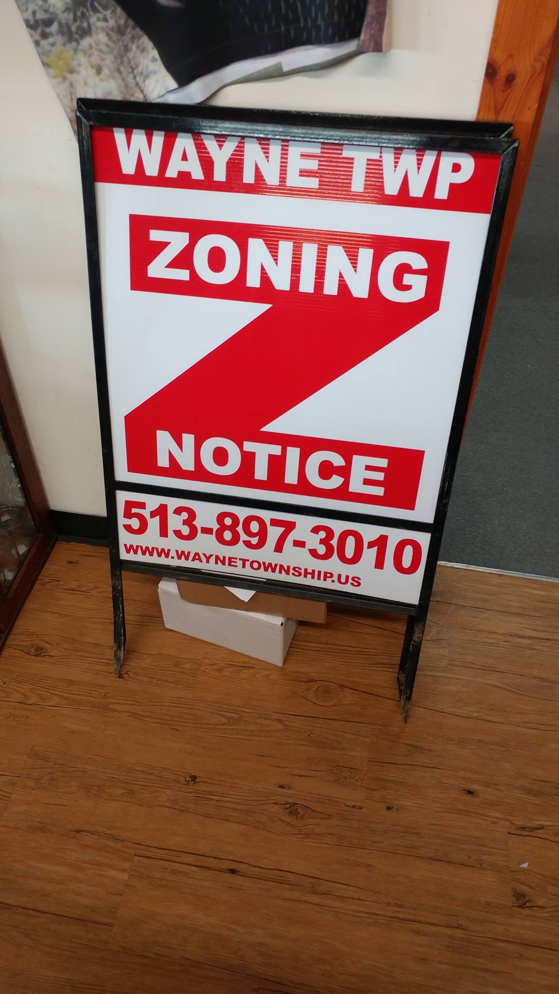 A Wayne Township zoning notice sign with a large red letter Z on a white background, including phone number 513-897-3010.