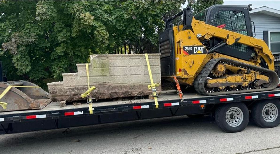A bulldozer is sitting on top of a flatbed trailer.