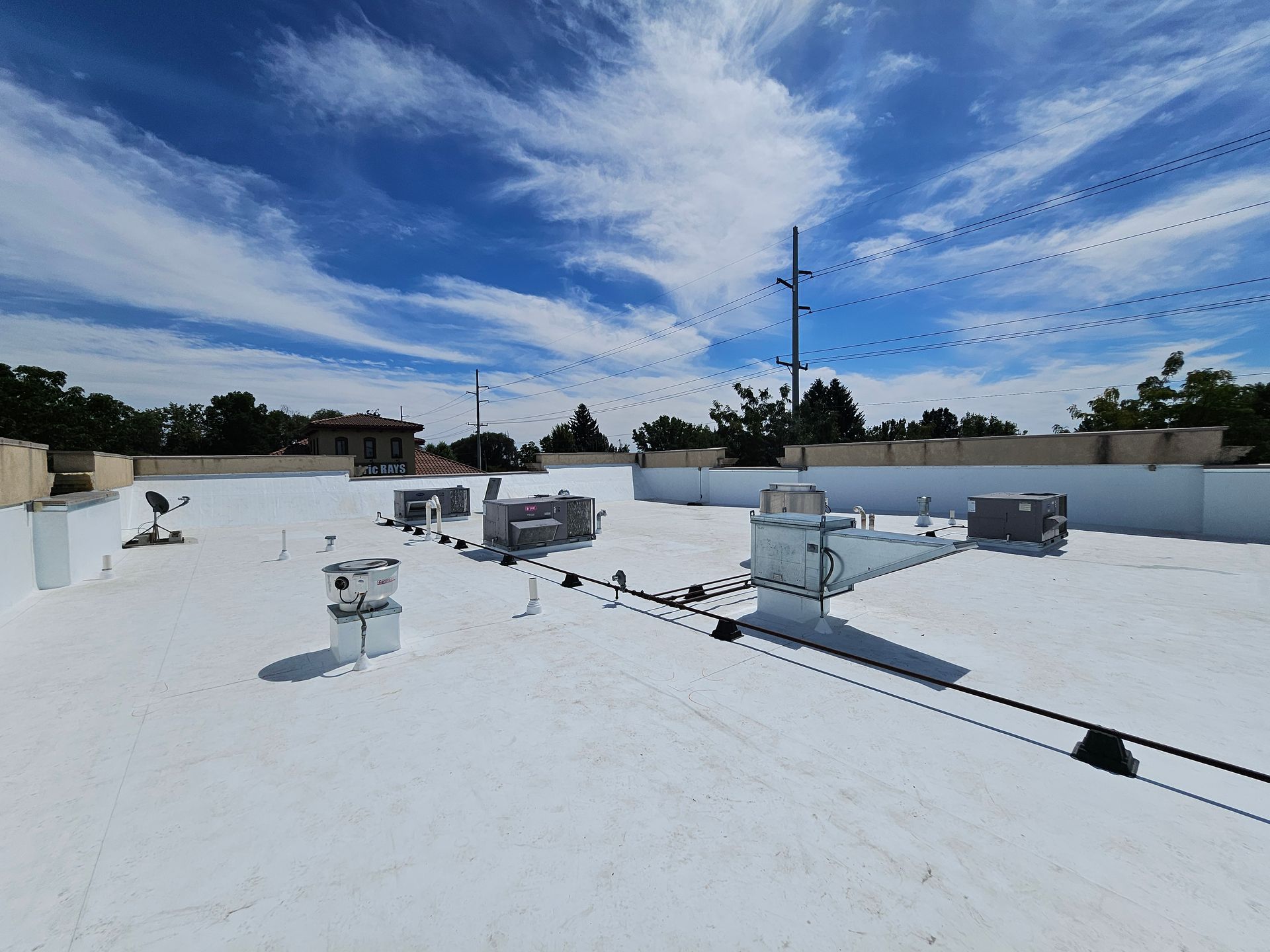 Air conditioning units on a flat rooftop, cooling a building.