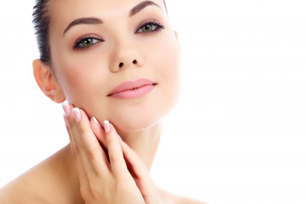 young white woman with nice skin touching her face