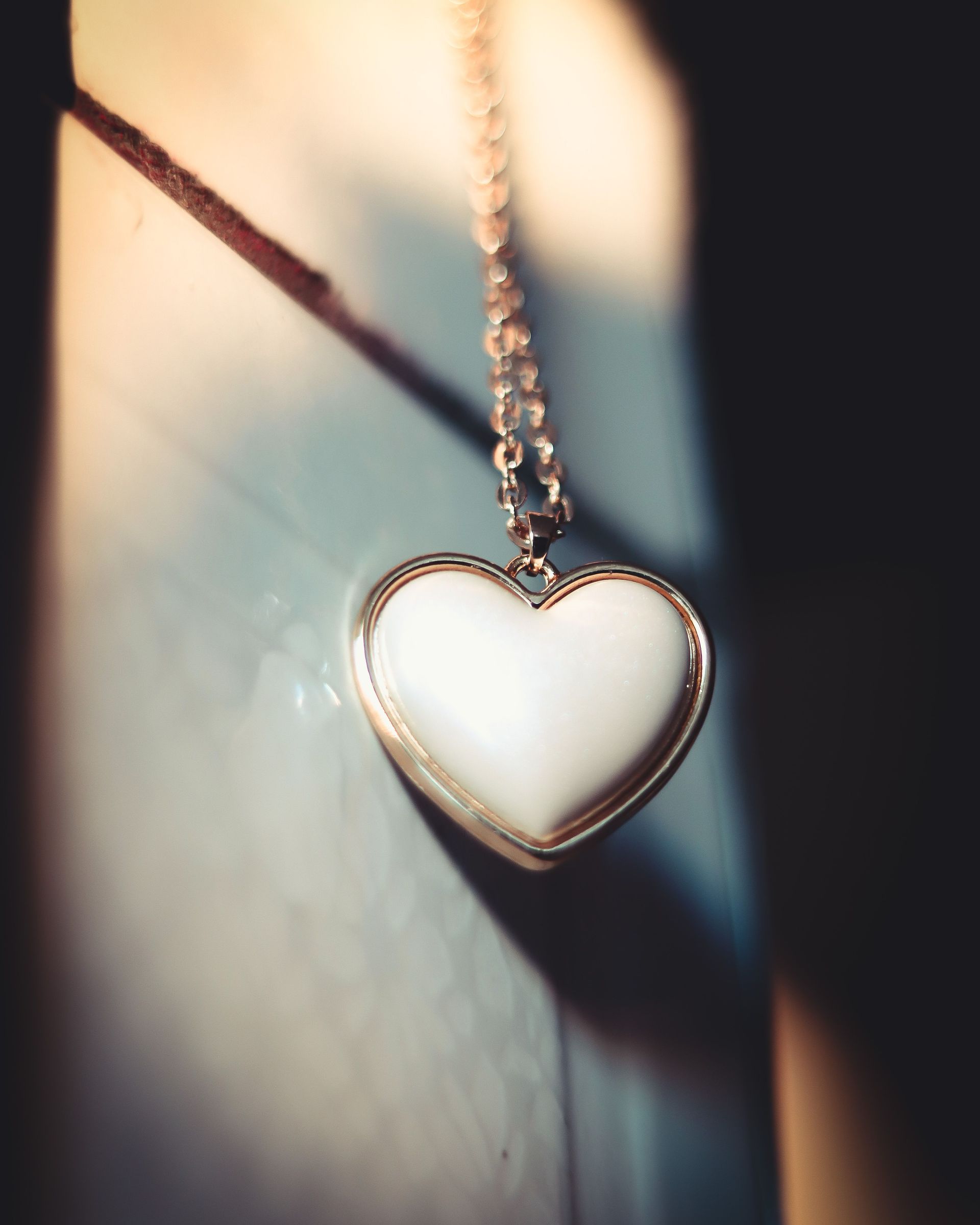 Heart-shaped pendant necklace on a soft, shadowed background
