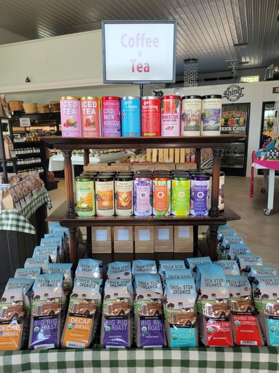 Coffee and tea display shelves with colorful drink boxes in a store aisle