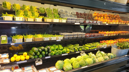 Produce display of assorted fresh fruits and vegetables in a grocery store