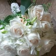White rose bouquet with green leaves and small white flowers