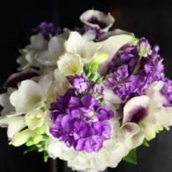 White and purple bouquet of flowers on a dark background