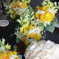 White and yellow flower bouquets arranged on a table