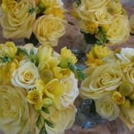 Yellow and white rose bouquets wrapped in clear plastic
