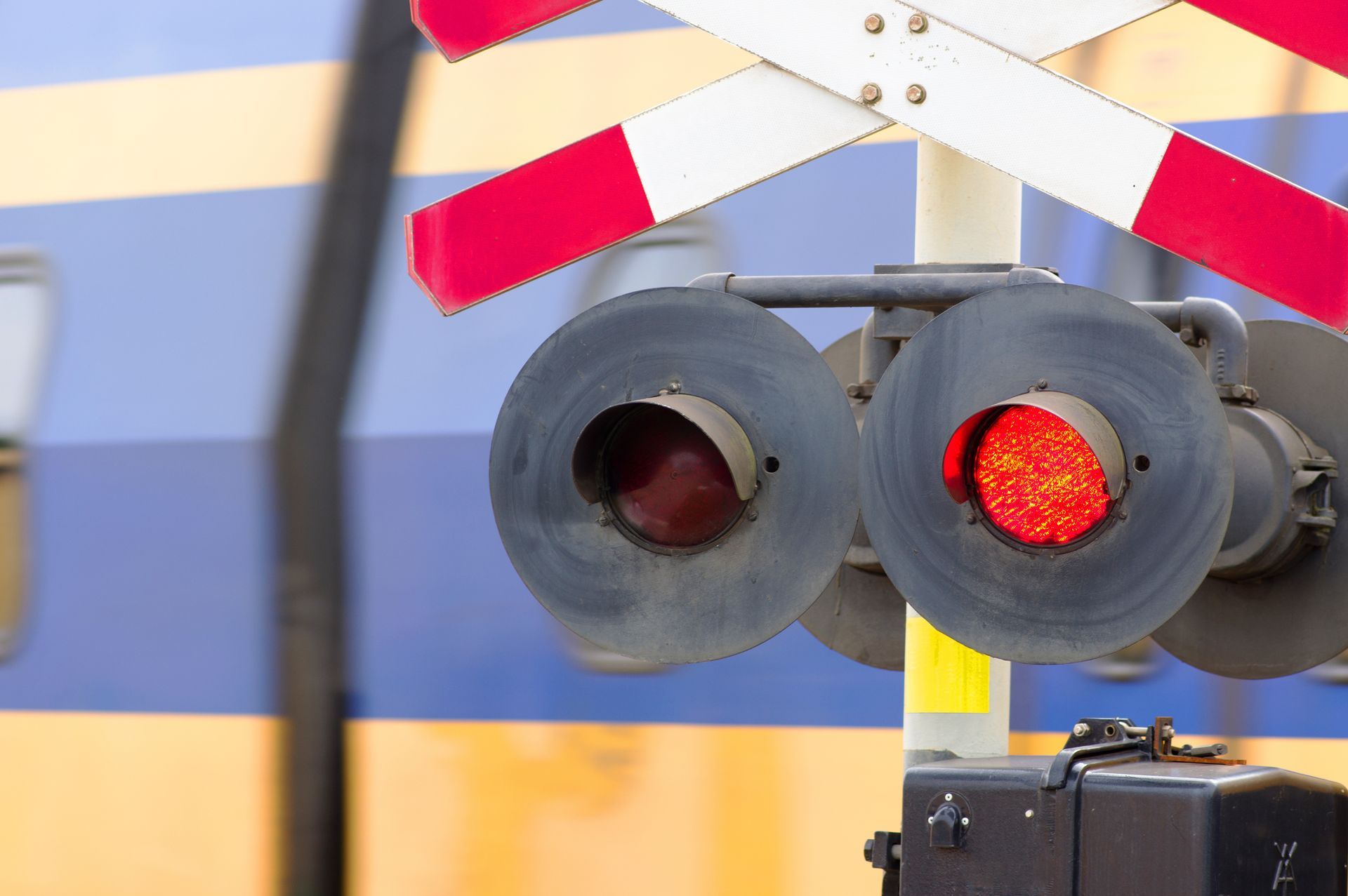 rail signal light with a level crossing signal behind