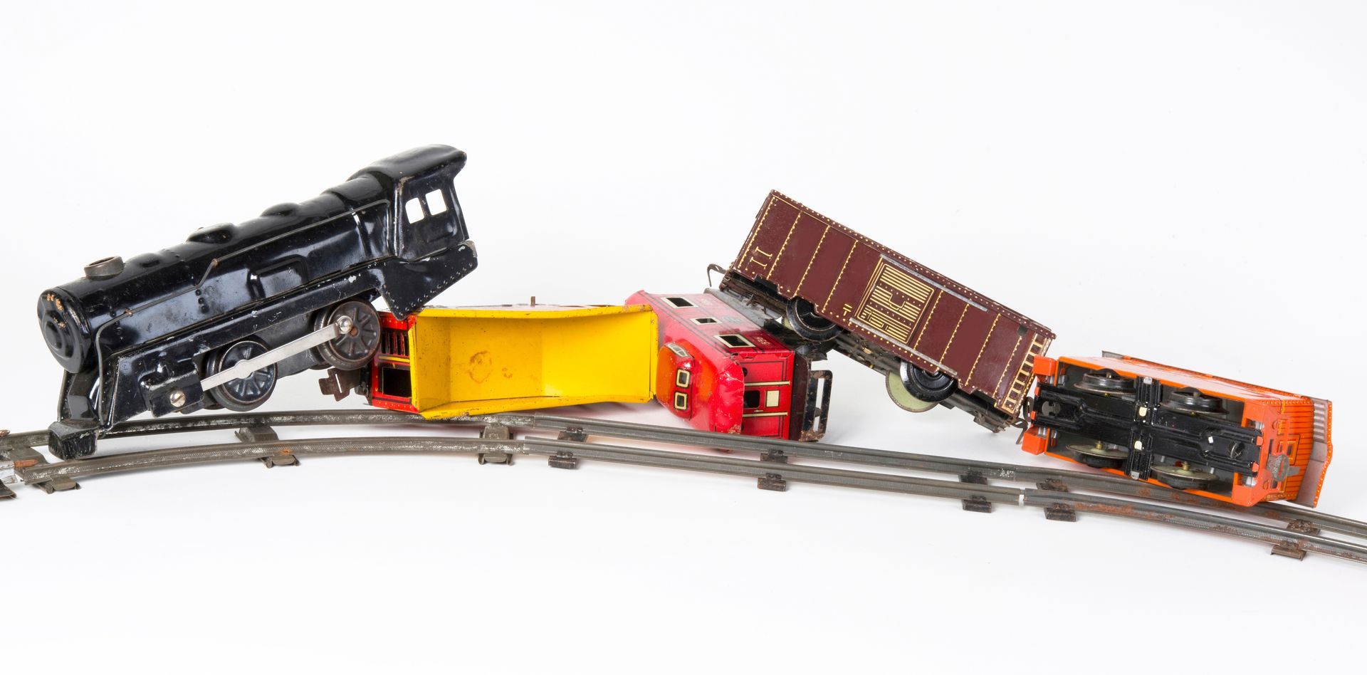 A toy train is sitting on top of a train track.