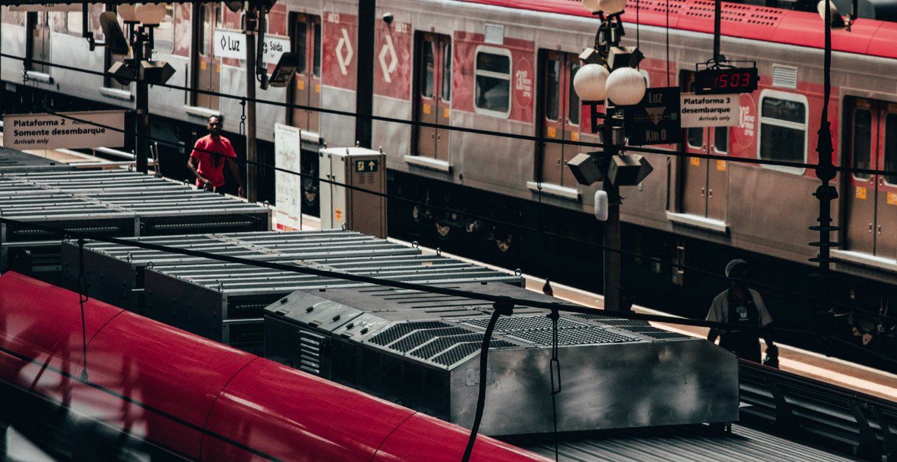 A red train is pulling into a train station.