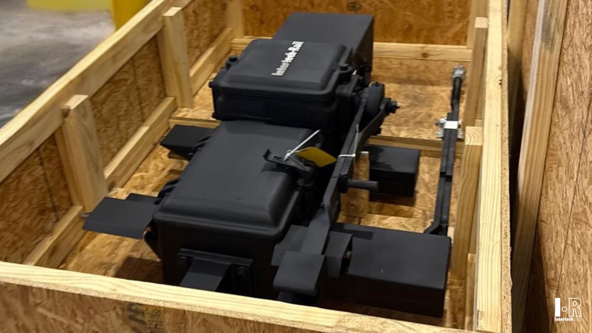IRM23 switch machine by Intertech Rail secured inside a wooden shipping crate.