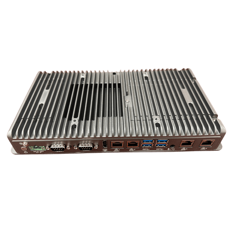 Silver industrial computer with ribbed top, various ports along one side.