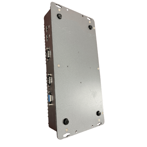Bottom view of a small, gray computer with black rubber feet, ports on the side.